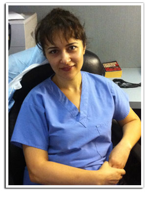 The image shows a woman sitting at a desk with her arms crossed, wearing professional attire, likely an office environment.