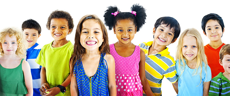 The image shows a group of children of various ages and ethnicities standing together with smiles on their faces.